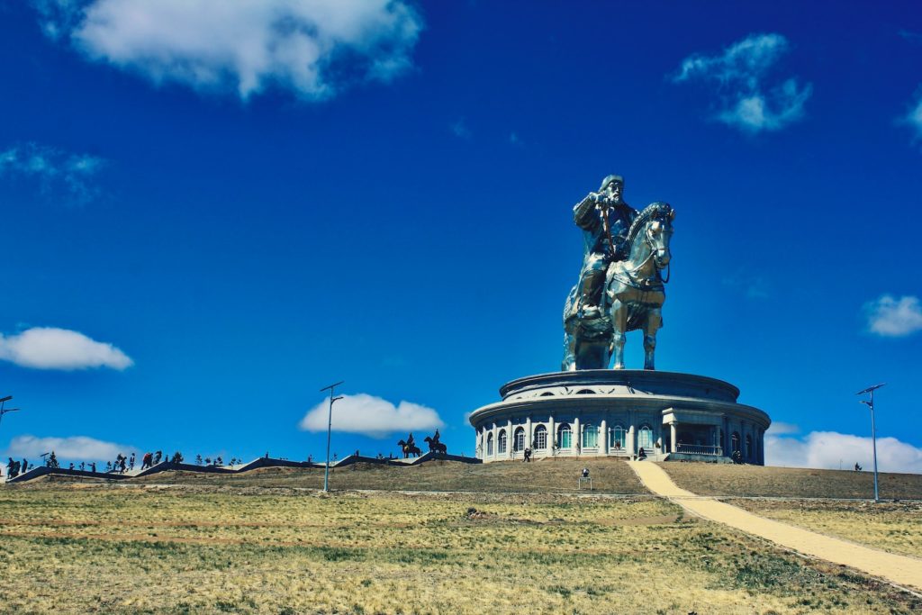 man riding horse statue under blue sky during daytime